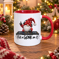 Festive DJ Gonk 11oz ceramic Christmas mug with red handle and interior, featuring a gonk wearing headphones behind DJ decks and the slogan Put a GONK on it. Designed and printed by South Shore Gifts.