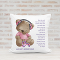 Personalised sensory bear cushion featuring a teddy in a pink T-shirt with pink ear defenders, comforting poem and child's name.