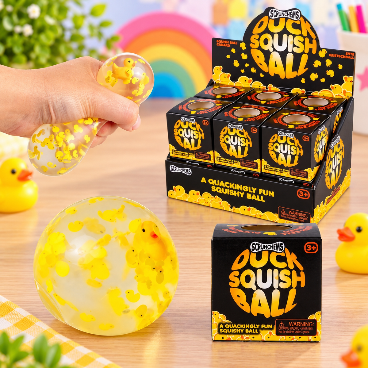 Scrunchems Duck Squish Ball sensory toy featuring a clear squeezable ball filled with yellow duck shapes and a mini floating resin duck.