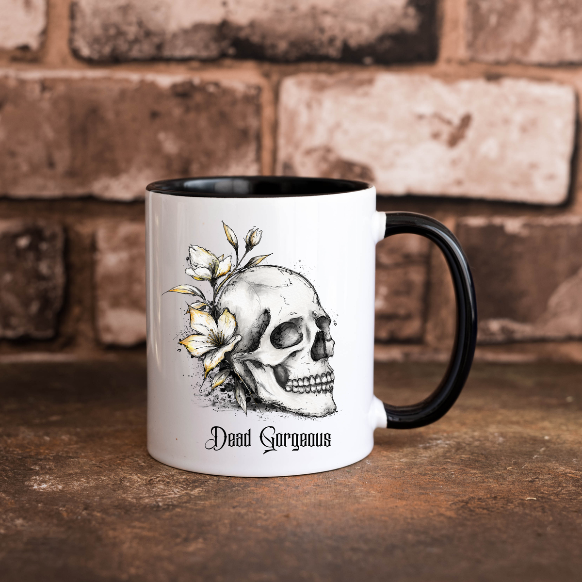 Dead Gorgeous 11oz gothic ceramic mug featuring a black and white floral skull illustration, gothic lettering, black handle and black interior.