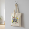 Tote bag with motivational quote hanging on a wooden door