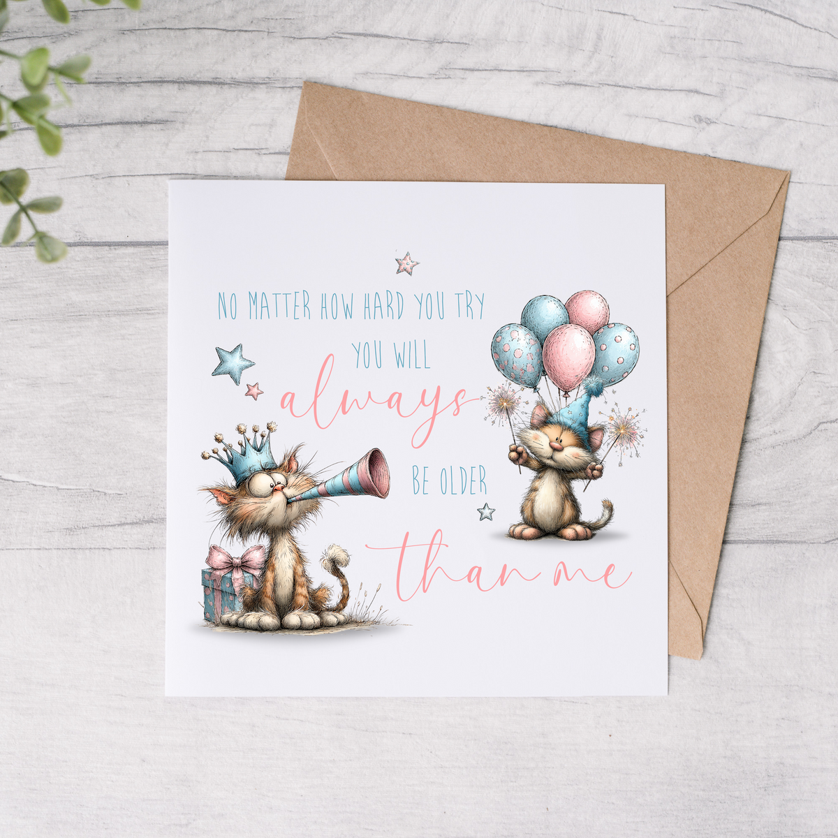 Greeting card with cartoon cats and balloons on a wooden surface