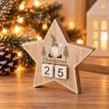 Rustic wooden star Christmas countdown decoration featuring a grey and white gonk, grey trees and white number blocks .